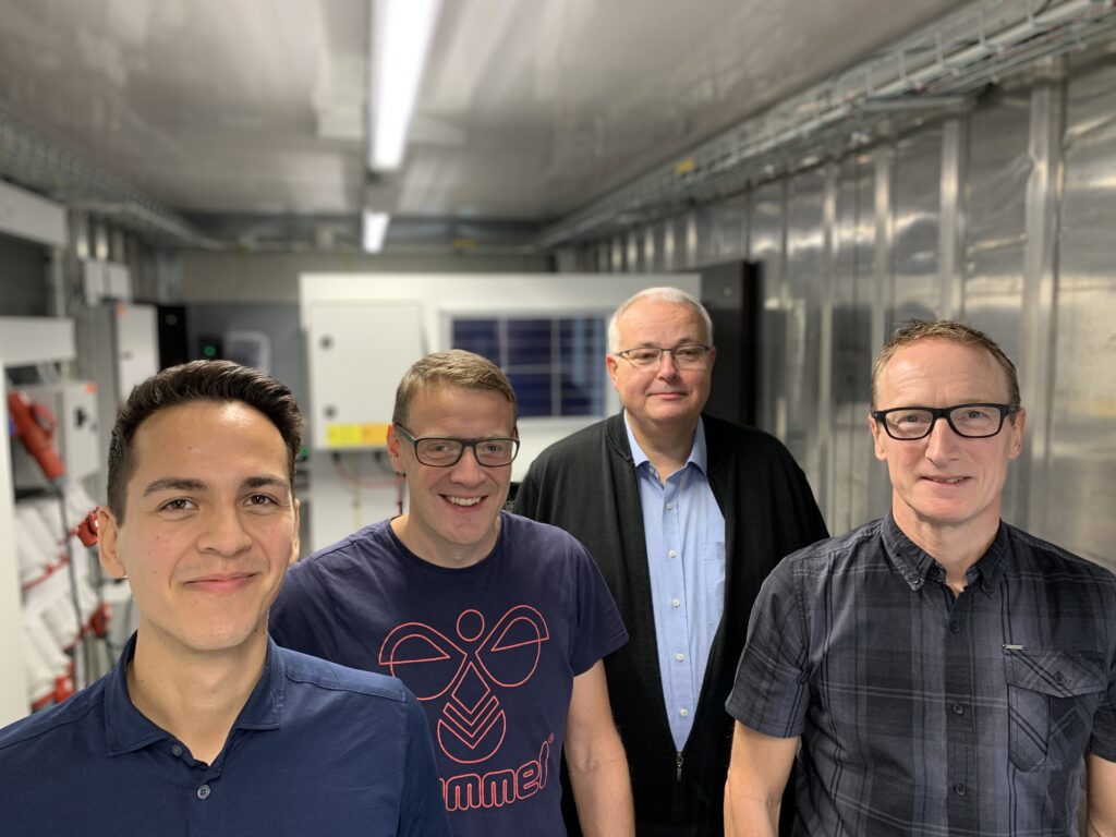 Tobias Malik Vermehren, Thomas Christensen, Jesper Blankenfeldt, and Jakob Normann Olesen in the PowerAdapt Test lab.
