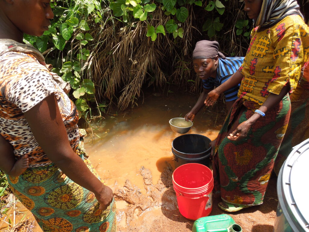 Women collecting water from Mazungwe Spring in Western Tanzania