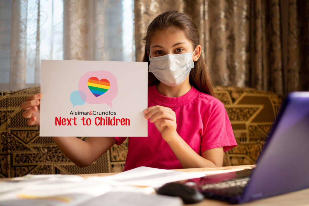 Girl with facemask holding Next to children sign