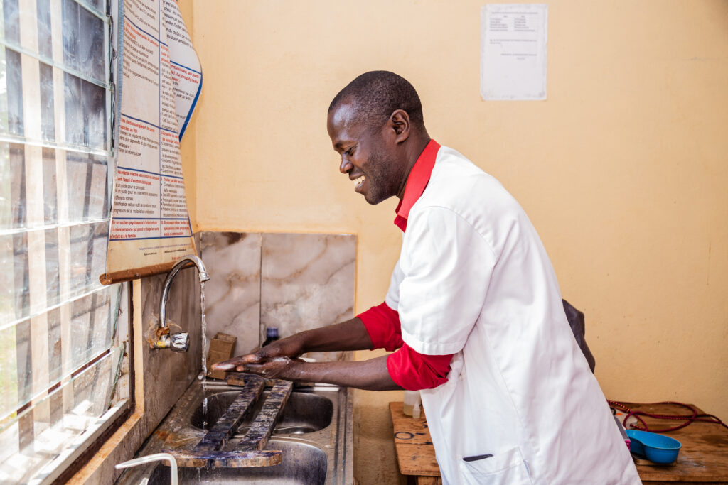 Doctor washing hands at Sigu Health Center