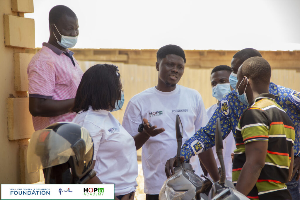 MacCarthy Mac-Gbathy (centre), Co-Founder and Executive Director of HOPin Academy, in discussion with stakeholders.