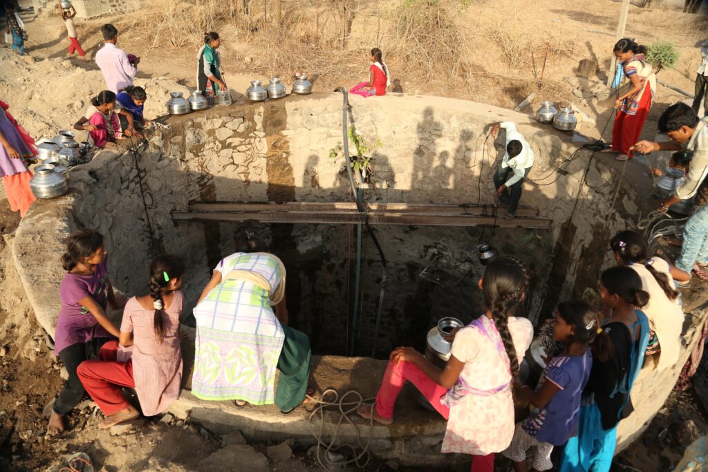 Fetching water from an open well.