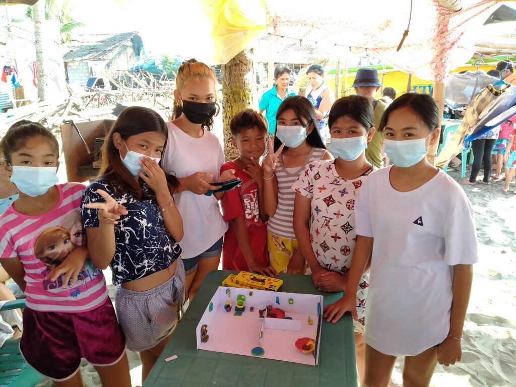 Children posing with model of toilets. Photo: Water & Life Philippines