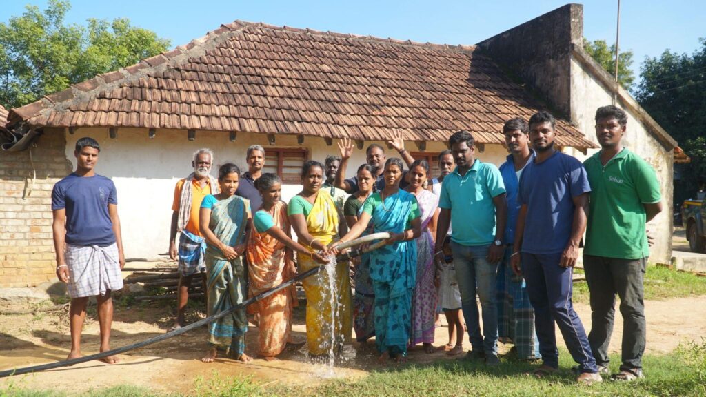 Beneficiaries receiving water at their habitation area just after the installation of solar pump. Credit: Induja Gandhiprasad