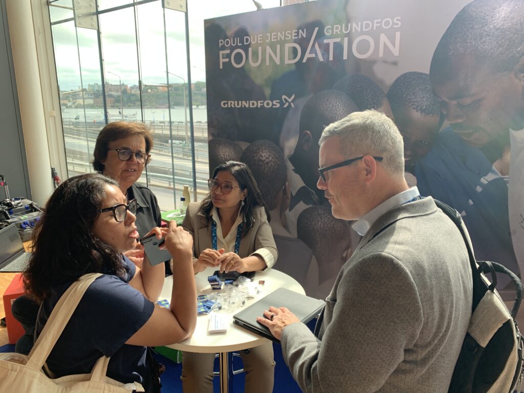 People in discussion at the Foundation's exhibition booth