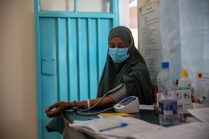 Hani Aweis, 24-year-old refugee mother from Somalia, has her blood pressure taken at Locher Ang’amor health clinic in Kakuma camp