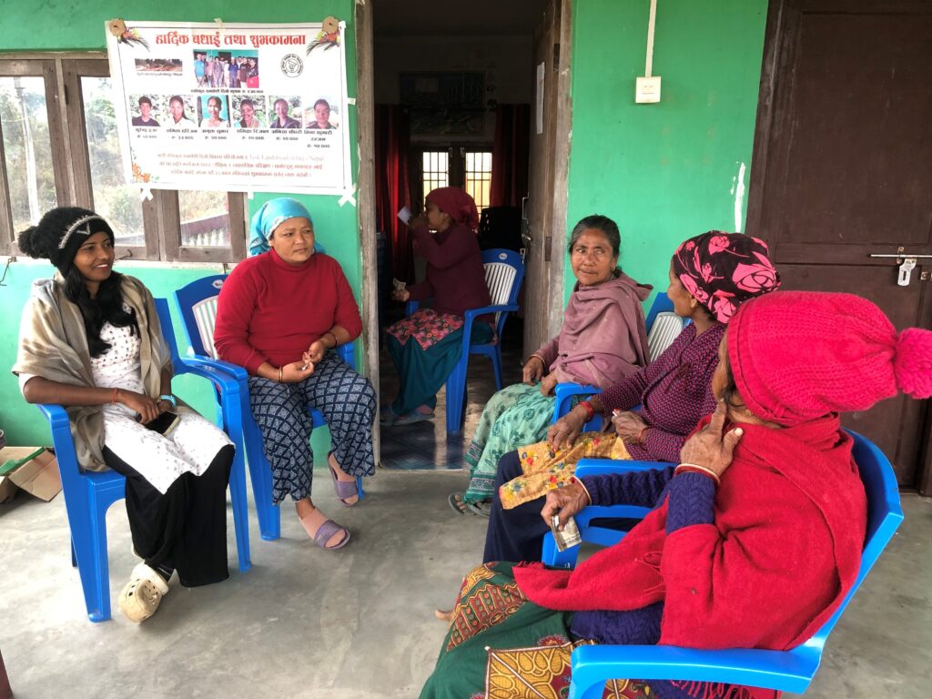 Group of people, mostly women, sitting and discussing.